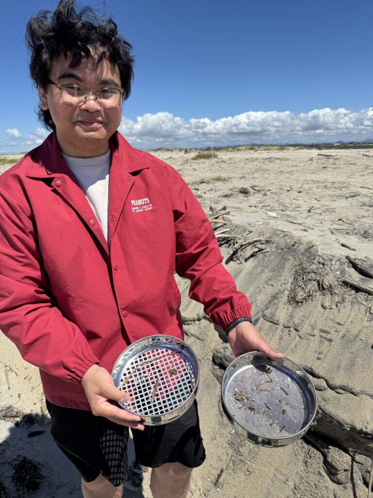 Student sifting a sediment sample on the beach — Black Tech Link BIPOC Coastal Research Program (BCRP)